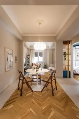 a dining room and living room with a table and chairs at Immaculate Modern Kypseli Apt - Next to Kanari Sq in Athens
