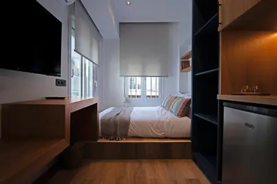 a bedroom with a bed and a tv in a room at Blum Residence Athens in Athens