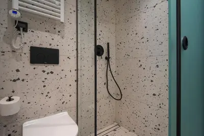 a bathroom with a shower with a toilet in it at Blum Residence Athens in Athens