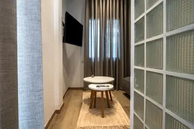 a small white table in a room with a window at Blum Residence Athens in Athens