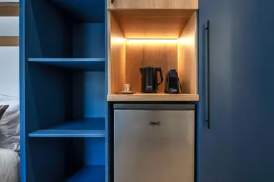 a cupboard with a coffee maker in it at Blum Residence Athens in Athens