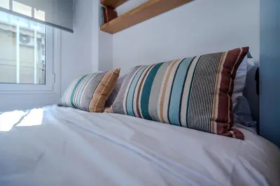 a bed with two pillows on it with a window at Blum Residence Athens in Athens