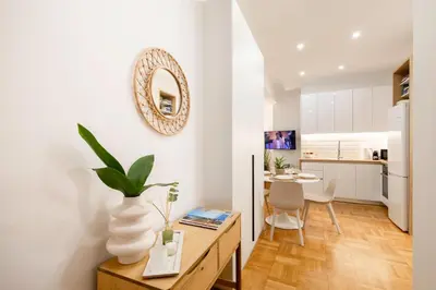 a kitchen and living room with a table and a dining room at Kolonaki Prestige - Greecing in Athens