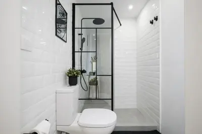 a white bathroom with a toilet and a shower at Kolonaki Prestige - Greecing in Athens
