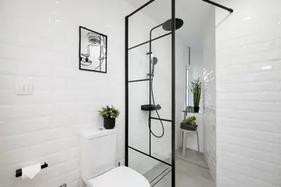 a bathroom with a toilet and a glass shower at Kolonaki Prestige - Greecing in Athens