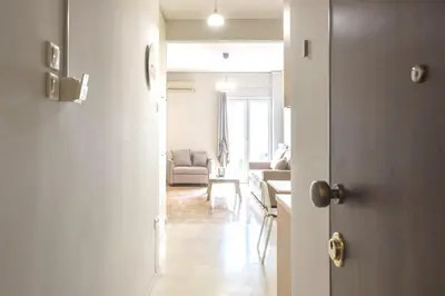 an open door to a living room with a couch at Urban Comfort Stay in Athens