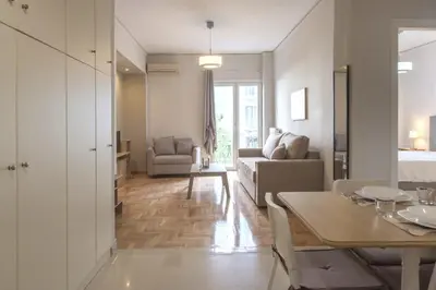 a living room with a table and a couch at Urban Comfort Stay in Athens