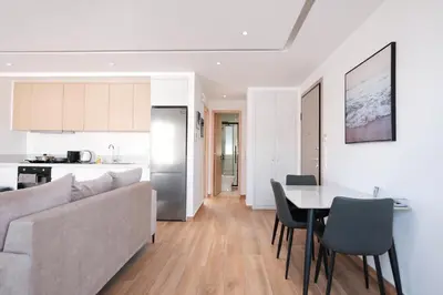 a living room and kitchen with a couch and a table at Near Pireas Port-Brand New Suite in Athens