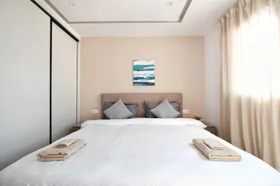 a bedroom with a bed with two towels on it at Near Pireas Port-Brand New Suite in Athens