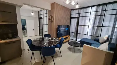 a living room with a table and blue chairs at Heart of Athens Luxury 2BR#8 in Athens