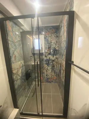 a shower with a glass door in a bathroom at Heart of Athens Luxury 2BR#8 in Athens