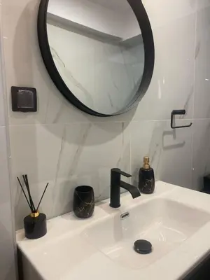 a bathroom sink with a mirror and a black faucet at Heart of Athens Luxury 2BR#8 in Athens