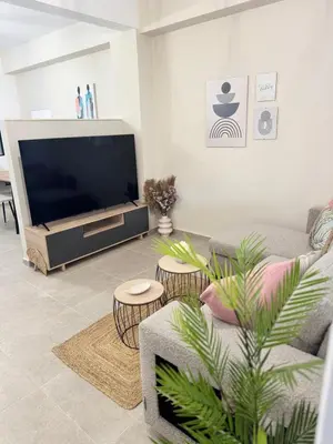 a living room with a tv and a couch at Athens Soul stay#7 in Athens