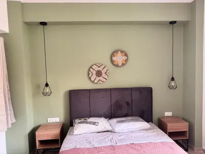 a bedroom with a bed and two clocks on the wall at Athens Soul stay#7 in Athens