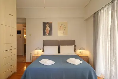 a bedroom with a bed with two towels on it at Family Flat for 4 next to the Flisvos Marina by Filos Inc in Athens