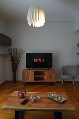 a living room with a tv and a coffee table at Family Flat for 4 next to the Flisvos Marina by Filos Inc in Athens
