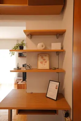 a shelf in a room with a wooden table at Family Flat for 4 next to the Flisvos Marina by Filos Inc in Athens