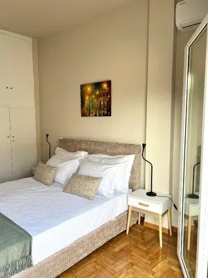 a bedroom with a large bed with white pillows at AK Athens Fine Stay - Penthouse with Big Terrace and View - 2 min from Metro in Athens