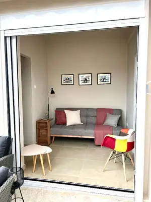 a living room with a couch and some chairs at AK Athens Fine Stay - Penthouse with Big Terrace and View - 2 min from Metro in Athens