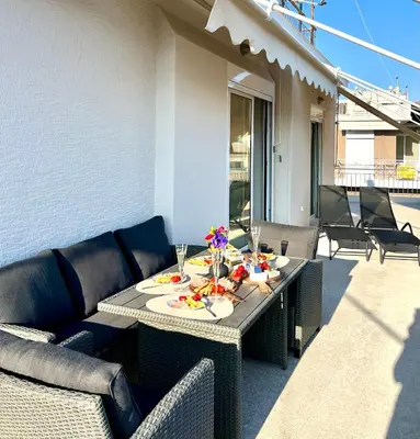 a table with food and drinks on a patio at AK Athens Fine Stay - Penthouse with Big Terrace and View - 2 min from Metro in Athens