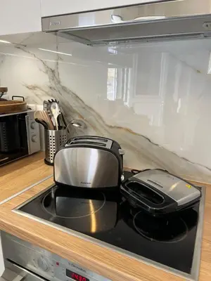 a toaster sitting on top of a stove in a kitchen at AK Athens Fine Stay - Penthouse with Big Terrace and View - 2 min from Metro in Athens