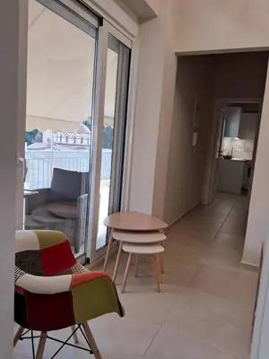 a room with a table and chairs and a balcony at AK Athens Fine Stay - Penthouse with Big Terrace and View - 2 min from Metro in Athens