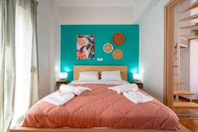 a bedroom with a large bed with towels on it at Breezy Maisonette in Zea for 5 by Filos Inc in Piraeus