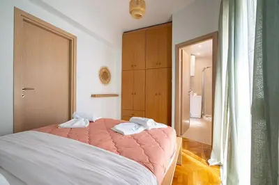 a bedroom with a bed with two towels on it at Breezy Maisonette in Zea for 5 by Filos Inc in Piraeus