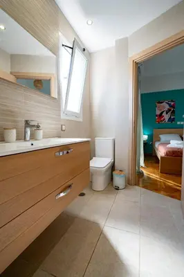 a bathroom with a toilet and a sink and a bed at Breezy Maisonette in Zea for 5 by Filos Inc in Piraeus