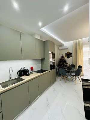 a kitchen with green cabinets and a christmas tree at Downtown Lux apartment in Athens