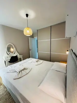 a bedroom with a large white bed and a mirror at Downtown Lux apartment in Athens