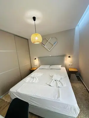 a bedroom with a white bed and a light at Downtown Lux apartment in Athens