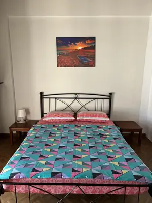 a bed with a colorful quilt on it in a bedroom at Onix 4 in Athens