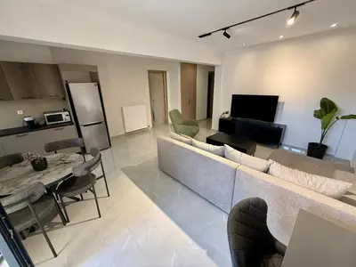 a living room with a couch and chairs and a television at Comfort SpataAir Stay in Spáta