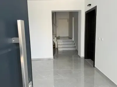 a hallway with white walls and a hallway with stairs at Comfort SpataAir Stay in Spáta