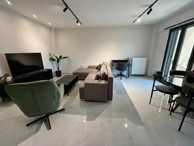 a living room with a couch and a table at Comfort SpataAir Stay in Spáta