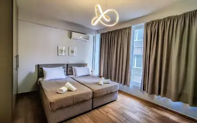 a bedroom with a bed with two towels on it at Chic New Apt with Acropolis View in Monastiraki in Athens