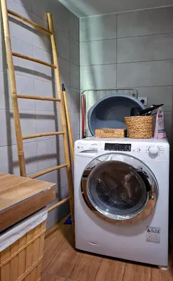 a washing machine in a kitchen next to a ladder at Chic New Apt with Acropolis View in Monastiraki in Athens