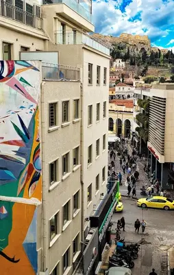 a building with a mural on the side of it at Chic New Apt with Acropolis View in Monastiraki in Athens