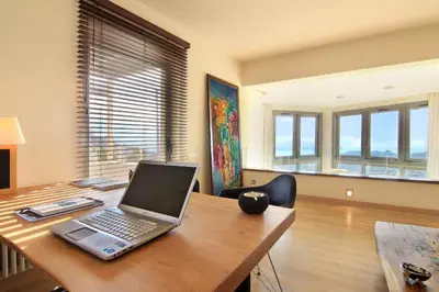 a laptop computer sitting on a wooden desk at Villa TakeOff Saronida in Anavissos