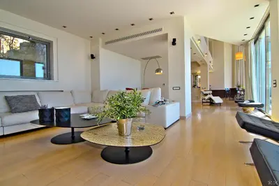 a living room with a couch and a table at Villa TakeOff Saronida in Anavissos