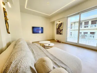 a living room with a couch and a tv at Prestige in Athens