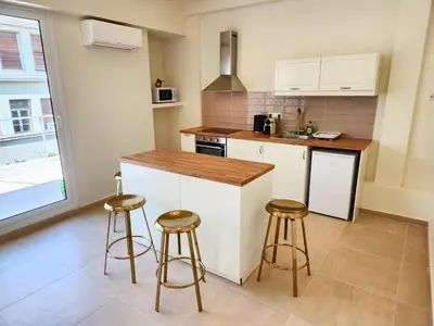 a kitchen with a counter and stools in it at Prestige in Athens