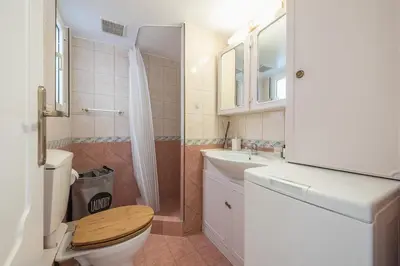 a bathroom with a toilet and a sink and a shower at Lycabettus View Top Floor 2BdApt in Athens