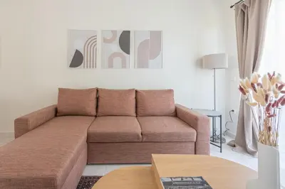 a living room with a brown couch and a table at Lycabettus View Top Floor 2BdApt in Athens