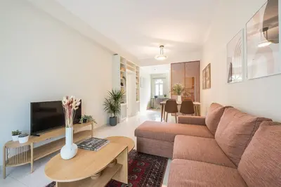 a living room with a couch and a table at Lycabettus View Top Floor 2BdApt in Athens