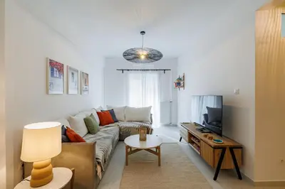 a living room with a couch and a tv at Cozy 3 bdr Apartment next to Acropolis in Athens