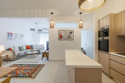 a kitchen and a living room with a couch at Cozy 3 bdr Apartment next to Acropolis in Athens