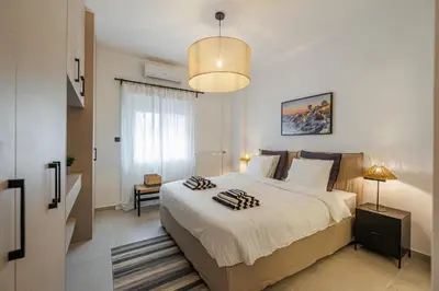 a bedroom with a large bed with two pillows on it at Cozy 3 bdr Apartment next to Acropolis in Athens