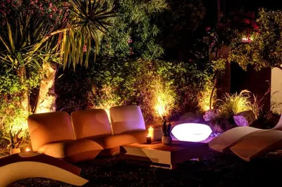 a living room with a couch and a table and lights at Cyan Villa in Anavissos